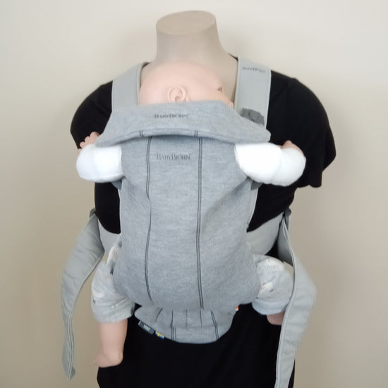 Baby Bjorn Mini carrier in grey being worn by a mannequin