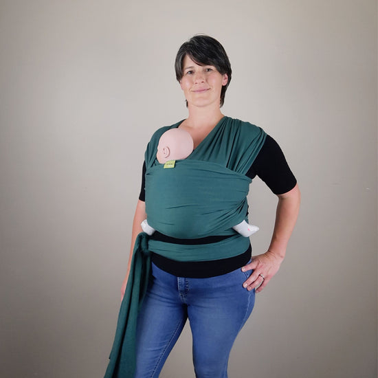 New Zealand Babywearing Educator Sarah wearing a demo doll in a green Boba Serenity Wrap