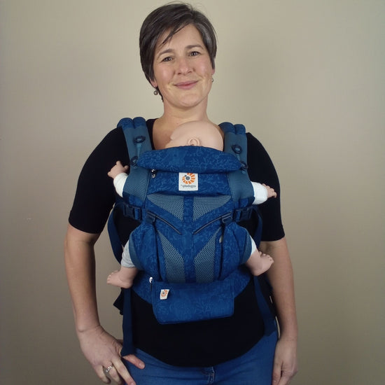Auckland babywearing consultant Sarah from Joy Riders wearing a demo doll in a navy Ergobaby Omni 360 Cool Mesh