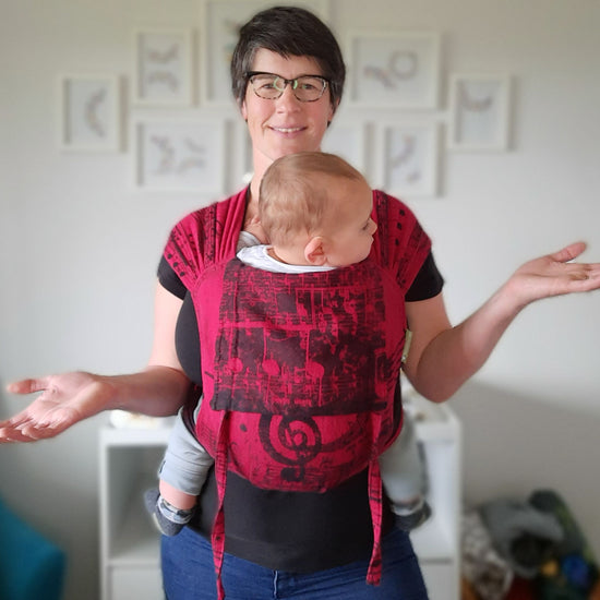 Auckland babywearing educator Sarah, wearing her child in a symphony meh dai from lenny lamb