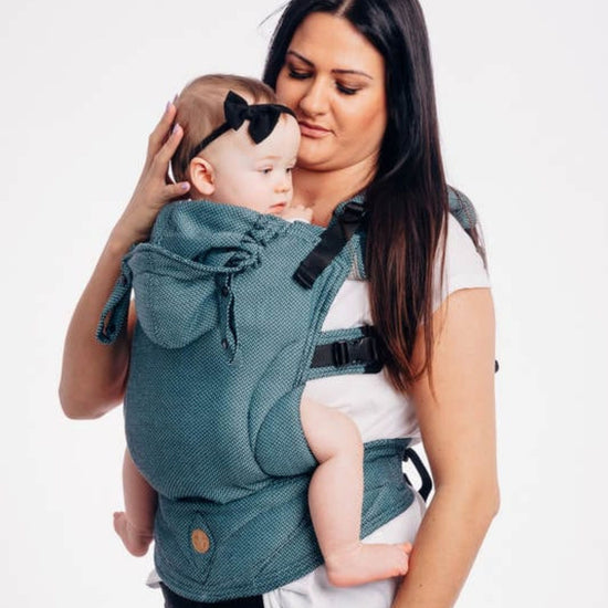 woman wearing infant in toddler lenny lamb buckle carrier