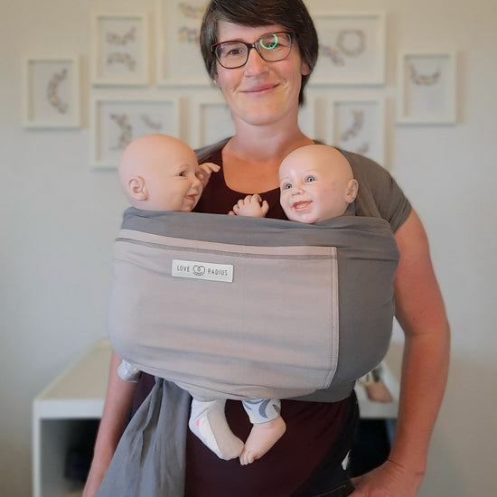 New Zealand babywearing consultant Sarah wearing twin demo dolls in the original love radius wrap