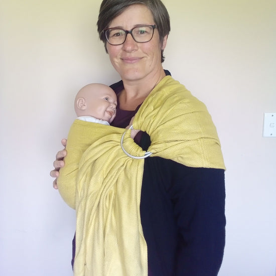 Babywearing consultant from Joy Riders demonstrating a Sakura Bloom ring sling with a doll