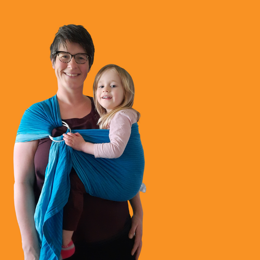 Auckland Babywearing consultant Sarah wearing a preschooler in a blue gradient ring sling