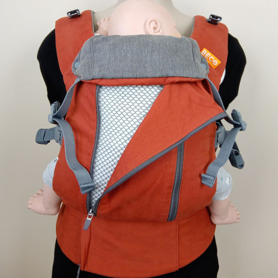 Rust coloured Beco Eight carrier being worn by a mannequin