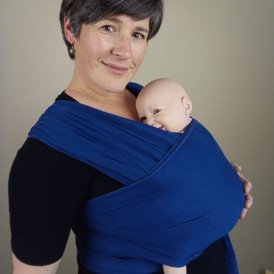 Joy Riders babywearing consultant wearing demo doll in Ergobaby Aura wrap