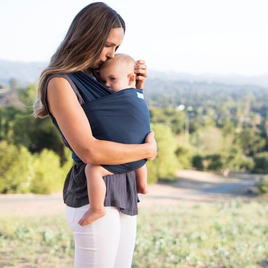 Woman wearing an infant in a Moby Stretchy Wrap